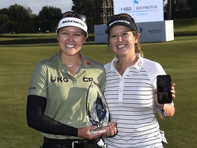 Smiths Falls native Brooke Henderson holds the championship trophy while her sister/caddie Brittany holds a mobile while doing a face time with their parents after winning the HUGEL-AIR PREMIA LA Open on Saturday, April 24.
Kevork Djansezian/Getty Images