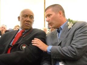 Paul Quantrill, right, talks with current hall-fo-famer Fergie Jenkins, left, at his induction into the Canadian Baseball Hall of Fame in St. Marys in this file photograph from 2010. A statue honouring Jenkins, a native of Chatham, is to be erected at the Chicago Cubs' Wrigley Field, it was announced April 5. File photo/Postmedia Network