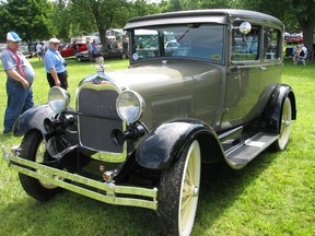 Spectators admire a 1928 Ford Model A at the Old Autos cars show in Bothwell. The car show, one of the largest in Ontario, is usually held in August but will not be held this year because of the COVID-19 pandemic. It was last held in 2019. Peter Epp/Chatham This Week