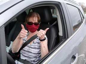 Kim DaPonte gives a thumbs up after receiving a dose of COVID-19 vaccine at a mobile vaccination clinic Thursday, April 15, 2021, at Wheatley Area Arena in Wheatley, Ont., More than 300 people were scheduled to be jabbed. The drive-thru clinic was fully booked. (Photo courtesy of Chatham-Kent Public Health)