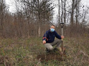 To commemorate Earth Day, Randall Van Wagner, Lower Thames Valley Conservation Authority's manager of conservation lands and services, plants a Black Oak sapling at a 25-acre property donated by East Kent resident Kenneth Ashton.