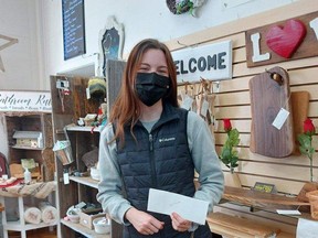Lexi Merner, a member of the Central Huron social enterprise endeavour, shows off her cheque from a summer of working with the bee project and community vegetable gardens. Handout