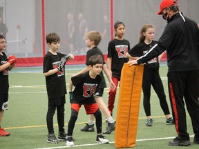 Hunter Orrbrooke awaits his turn at a tackling drill, co-ordinated by coach Costa Zarifi during a Mosquito Division(10-11-year-olds) workout last weekend at the Benson Centre fieldhouse. Photo on Sunday, March 28, in Cornwall, Ont. Todd Hambleton/Cornwall Standard-Freeholder/Postmedia Network