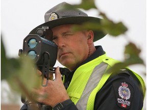 Const. Scott Sellsted, a traffic enforcement officer with the Edmonton Police Service's southwest division, looks through a radar gun in this September 2016 file photo.
