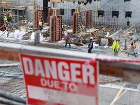 Construction workers build a condominium twer while other businesses are shut due to coronavirus restrictions in Toronto March 26, 2020.