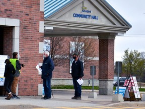 Area residents waited to receive their COVID-19 vaccines outside a vaccination clinic at the Stratford Rotary Complex arena recently. GALEN SIMMONS