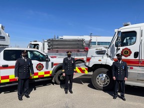First Class Firefighters Dale Krawec (left) and Robert Beer (right) are celebrated on April 14 by colleagues including Fire Chief Shawn Polley (center) for their time with Cochrane Fire. Town of Cochrane