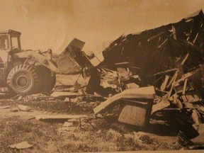 In this 1981 Today file photo, a bulldozer destroys a home belonging to a resident of Moccasin Flats near the Snye.