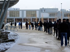 People line up outside of the Suncor Community Leisure Centre at MacDonald Island Park for a COVID-19 vaccine on Friday, April 23, 2021. Laura Beamish/Fort McMurray Today/Postmedia Network