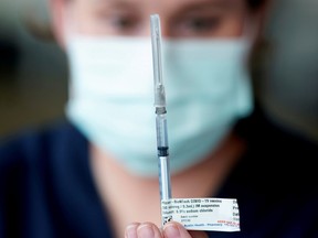 FILE PHOTO: A healthcare professional prepares a dose of the Pfizer coronavirus disease (COVID-19) vaccine.