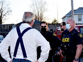 The founder of No More Lockdowns Canada, MPP Randy Hillier, confronts police at the "mask burning" event held at the South Branch Bistro in Kemptville on April 8. (HEDDY SOROUR/The Recorder and Times)
