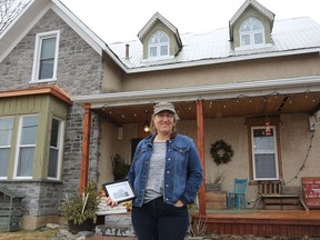 Nancy Kimmett holds a photograph of the First World War-era aviation hospital that is now her home on Gold Wing Ranch in Deseronto. The Kimmett farm, in her husband's family for generations, is the former site of the Royal Flying Corps aviation training facility, Camp Rathbun.