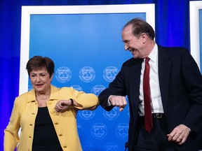 In this file photo taken on March 04, 2020, IMF managing director Kristalina Georgieva and World Bank Group president David Malpass bump elbows at the end of a joint news briefing on COVID-19 in Washington, D.C.