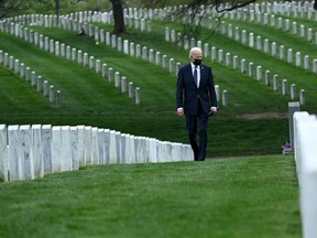 U.S. President Joe Biden walks through Arlington National cemetery to honour fallen veterans of the Afghan conflict in Arlington, Va., on April 14, 2021. Biden announced it's "time to end" America's longest war with the unconditional withdrawal of troops from Afghanistan, where they have spent two decades in a bloody, largely fruitless battle against the Taliban.