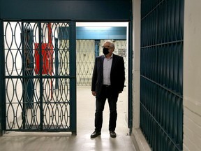 David St. Onge stands in the hallway between Kingston Penitentiary's recreation Hall and the main dome area on Friday, April 7, 2021, where many of the events of the April 1971 Kingston Penitentiary riot took place.