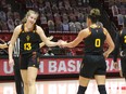 Kingston's Maggie Besselink, left, of the Arizona Sun Devils shakes hands with teammate and fellow Canadian Taya Hanson of Kelowna, B.C., during a game in the 2020-21 NCAA women's basketball season.
