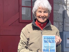 Mary Jane Philp of Kingston holds a copy of the book "A Good War," by author Seth Klein about the climate crisis in Canada. Philip ordered 338 copies of the book to be given to every member of Parliament.