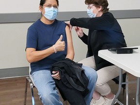 Xavier Kataquapit, a member of Attawapiskat First Nation and an urban Indigenous resident of Kirkland Lake, received his first shot of the Moderna vaccine from Sandra Dalpai, Nurse practitioner, Kirkland Lake Family Health Team, at a vaccination clinic held by the Timiskaming Health Unit in Kirkland Lake on Thursday April 15.