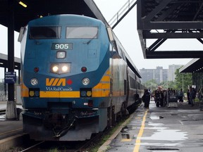 VIA customers board a Montreal-bound train, in this file photo from the Ottawa Train Station. High-frequency rail would be good for travellers and good for the environment, say four major city mayors.