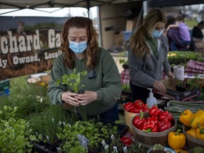 Christina Bouchard, left, and Chanel Bouchard, of Bouchard Gardens, work their booth at the season's first Amherstburg Farmer's Market held at GL Heritage Brewing in Amherstburg on Saturday, April 24, 2021.