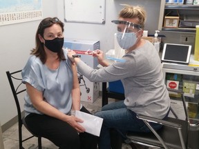 Southampton resident Judy Mitchell receives a COVID-19 vaccination from Kristen's Pharmacy owner and pharmacist Kristen Watt April 7 in Southampton.