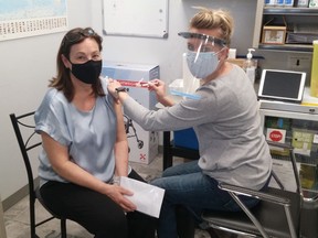 Southampton resident Judy Mitchell receives a COVID-19 vaccination from Kristen's Pharmacy owner and pharmacist Kristen Watt April 7 in Southampton. [Frances Learment]
