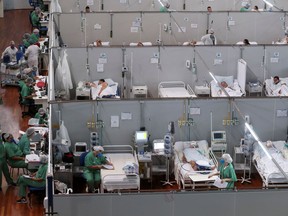 Health-care staff work next to patients suffering from COVID-19 at a field hospital set up at Dell'Antonia sports gym in Santo Andre, on the outskirts of Sao Paulo, Brazil, on Wednesday. Amanda Perobelli/Reuters