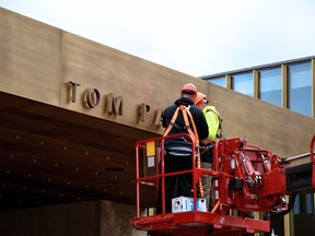 Contractors wire and install the lettering on the Stratford Festival's new Tom Patterson Theatre marquee.
