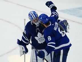 Toronto Maple Leafs defenceman Jake Muzzin (8) congratulates goaltender Jack Campbell (36) on setting a franchise record with 10 straight wins after a win against the Montreal Canadiens at Scotiabank Arena.