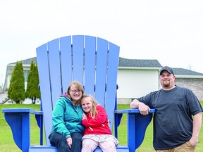 LARGER THAN LIFE Luke and Naomi check out the big blue chair at the top of Finn Hill with their daughter Paige, age six. BOB DAVIES/SAULT THIS WEEK