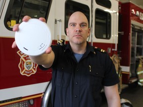 Mike Otis, fire life safety educator with Sarnia Fire Rescue holds a smoke detector in this file photo.