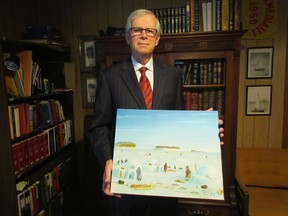 Ontario Superior Court Justice Joseph Donohue holds a painting depicting life during an earlier time in Kugluktuk, Nunavut in this 2015 file photo. Donohue, who retires from the bench this week, made several trips to Nunavut as a volunteer deputy judge.