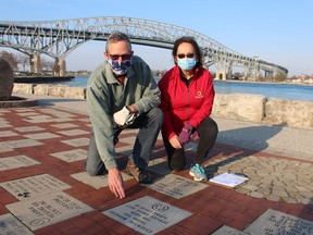 Pat and Karen Voegelin, with the Rotary Club of Bluewaterland, are show in this file photo next to a memorial stone for essential pandemic workers installed at the Rotary International Flag Plaza near the Blue Water Bridge.  (Picture file)