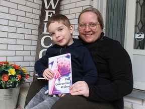 Jenna Strydonck and her son Lincoln, 4, hold a copy of her poetry collection, The Quarantine Widow.