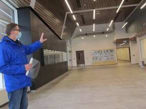 Brian McKay, superintendent of business for the Lambton Kent District school board, shows visitors the lobby in the newly completed theatre at Great Lakes secondary school in Sarnia.