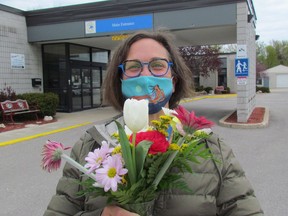 Marcy Draker, donor relations lead with Pathways Health Centre for Children, holds flowers outside the centre in Sarnia. The centre is holding a Meal for Momma fundraiser May 8 when meals, and bouquets, ordered ahead of time can be picked up.