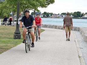 Cyclists are pictured along the trail in Point Edward that runs along the St. Clair River. (Observer file photo)
