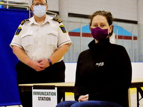 Sarah Page, left, Norfolk's chief of paramedic services and co-ordinator of Norfolk and Haldimand's COVID-19 vaccine rollout, and Joanna Cornish, a spokesperson for Norfolk County, at one of eight vaccination stations at the Delhi arena. Page and her team expect to vaccinate 12 individuals at the clinic every 10 minutes during peak periods. The Delhi clinic opens Friday.