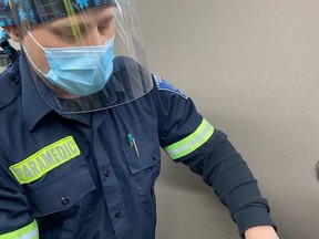 Norfolk County community paramedic Jeff Mullin administers a dose of vaccine to a resident at a recent vaccination clinic. Delivering vaccines is just one of many extra duties Norfolk paramedics, like their counterparts across the province, have taken on to help combat the COVID-19 pandemic.