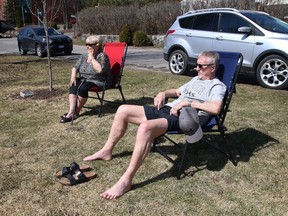 Dorinda and Fabian Harnett enjoy the warm weather while sitting near Bell Park in Sudbury, Ont. on Thursday April 8, 2021. John Lappa/Sudbury Star/Postmedia Network