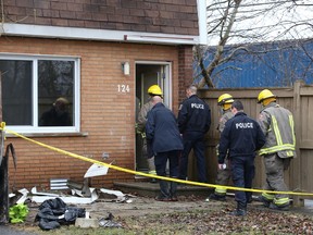 Greater Sudbury Police, members of the fire department and a representative of the Ontario fire marshal's office enter one of the damaged units at a housing complex fire in the Ryan Heights area on April 13. Police and the fire marshal's office are investigating the fire. The fire claimed its third victim on Monday.