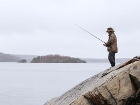 Kyle Lynch fishes in the rain at Ramsey Lake in Sudbury, Ont. on Tuesday April 13, 2021. John Lappa/Sudbury Star/Postmedia Network