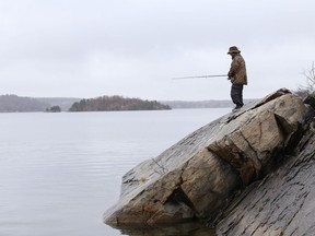 Kyle Lynch fishes in the rain at Ramsey Lake in Sudbury, Ont. on Tuesday April 13, 2021. John Lappa/Sudbury Star/Postmedia Network