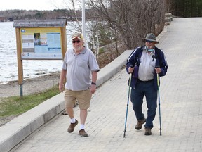 Clark Caverley, left, and Dale Brown went outside for some exercise in Sudbury, Ont. on Wednesday April 14, 2021. John Lappa/Sudbury Star/Postmedia Network