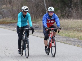 Judy Gougeon and Rob Poulin cycle at Delki Dozzi track in Sudbury, Ont. on Monday April 19, 2021. John Lappa/Sudbury Star/Postmedia Network