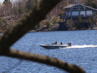 A boat skims across the water on Ramsey Lake on Friday.