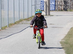 Jaden Rushton, 6, rides his bike with his grandmother at the Terry Fox Sports Complex in Sudbury, Ont. on Friday April 23, 2021. John Lappa/Sudbury Star/Postmedia Network