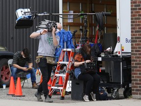 A production crew for Door Mouse prepares for shooting on Elm Street at Comics North in Sudbury, Ont. on Thursday April 29, 2021. Film director Avan Jogia said, "Door Mouse is a film I've written and am directing about the abuses of power, the corrosion of morality and a heroine who decides to stand up for herself and her community." John Lappa/Sudbury Star/Postmedia Network
