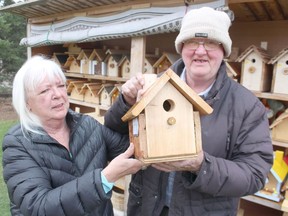 Linda and Clinton Hunter hold one of the birdhouses he made at his workshop in the backyard of their home in Plympton-Wyoming. He began making and selling birdhouses a decade ago as a way to stay busy in retirement. Paul Morden/Postmedia Network