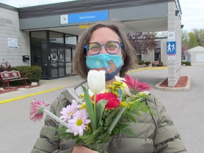 Marcy Draker, donor relations lead with Pathways Health Centre for Children, holds flowers outside the centre in Sarnia. The centre is holding a Meal for Momma fundraiser on May 8 when meals, and bouquets, ordered ahead of time can be picked up.